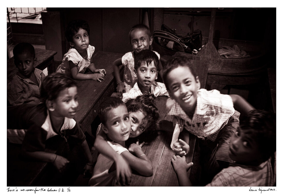 Children laugh and smile inside a night creche in the red light district, joy lighting up their faces