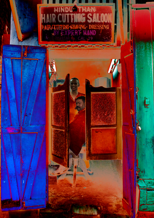 In negative format, a barber shop with open wooden doors reveals a man getting a haircut while another stands behind him